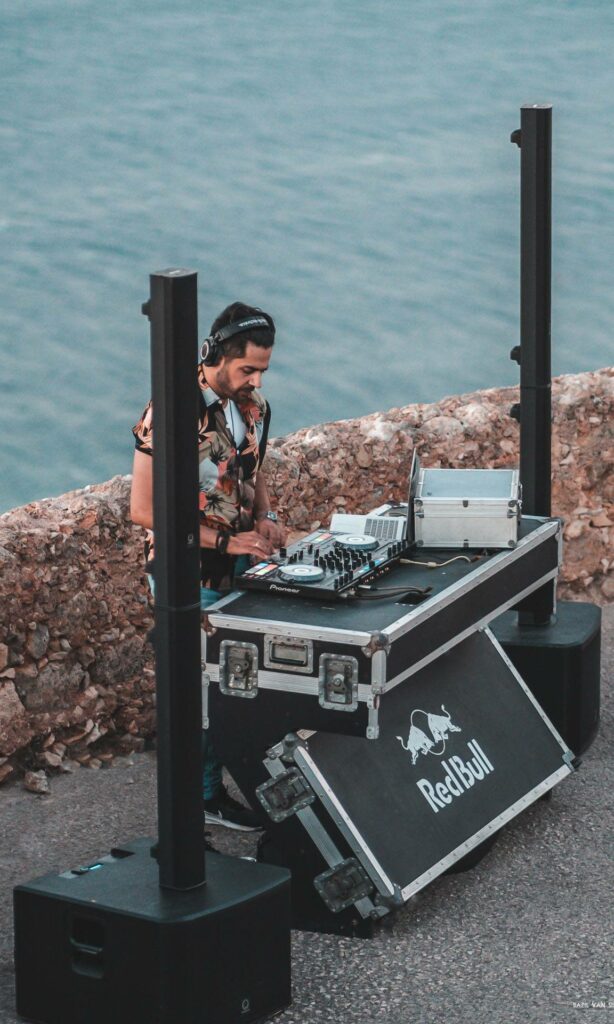 A picture of DJ MiAlpha performing at CastleFest Crete 2023, surrounded by Turbosound IP3000 speakers